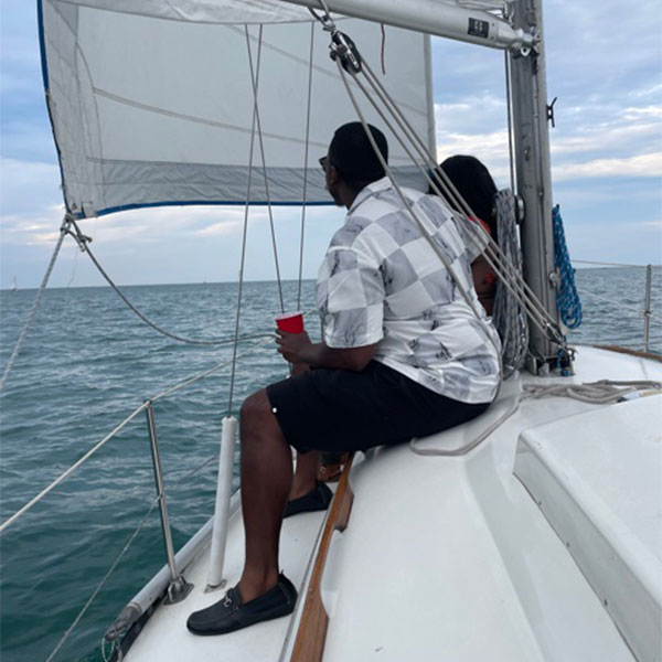 african american couple sitting and enjoying their time on a boat