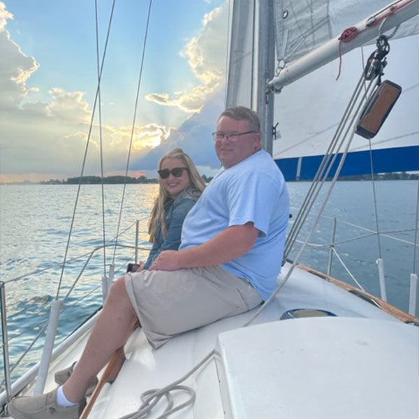 couple taking a photo on a boat on a cloudy day