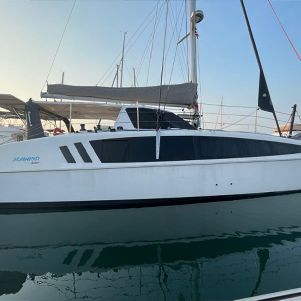 photo of one side of a white boat on a dock