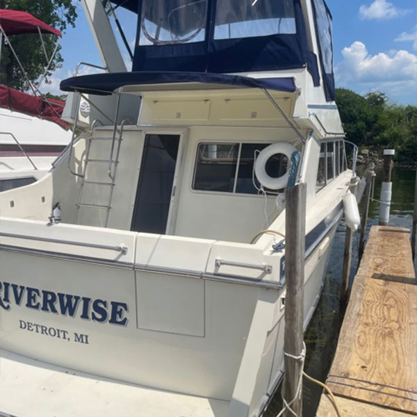 photo of the back of a white boat on a dock